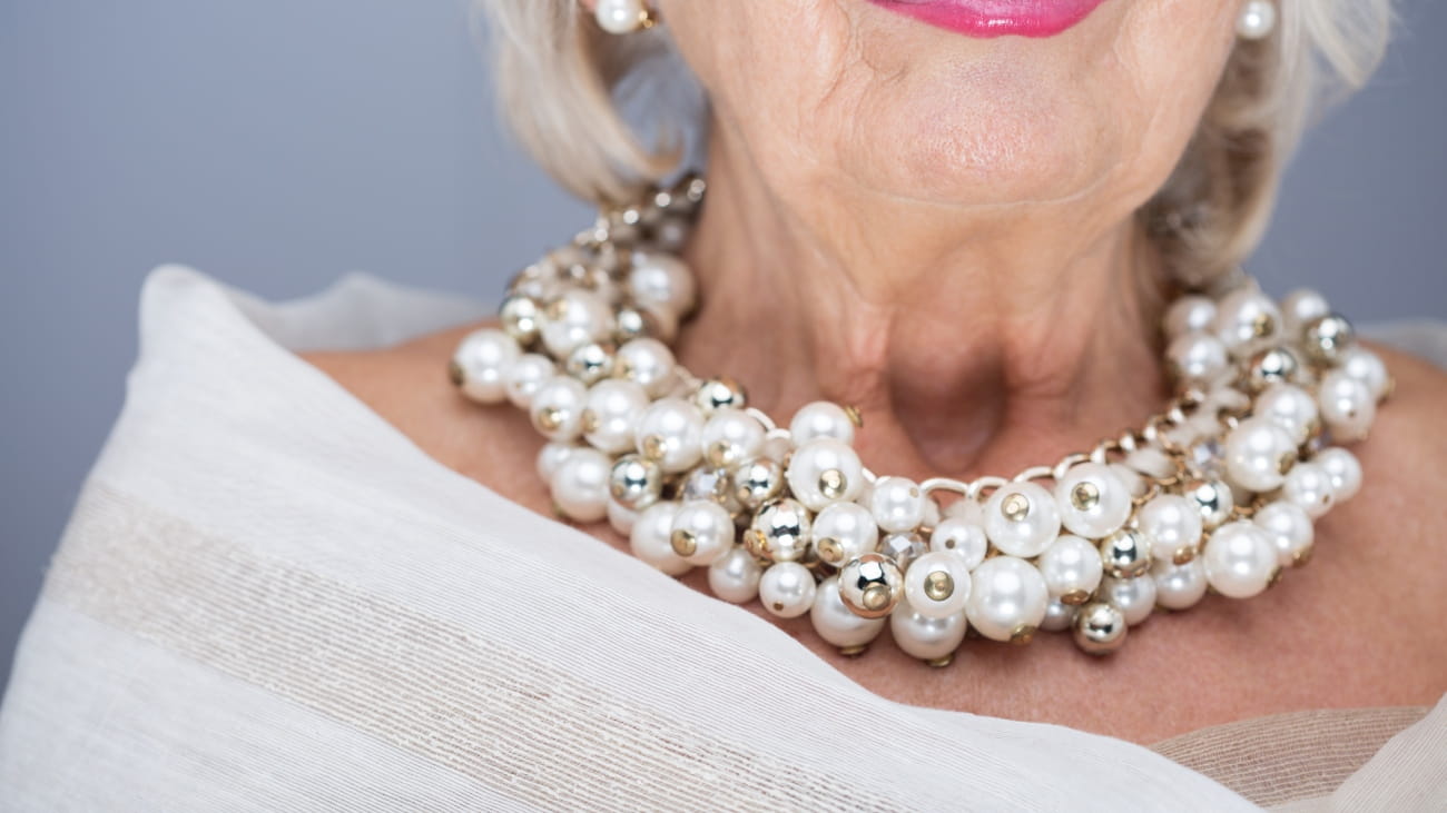 A lady wearing an impressive necklace