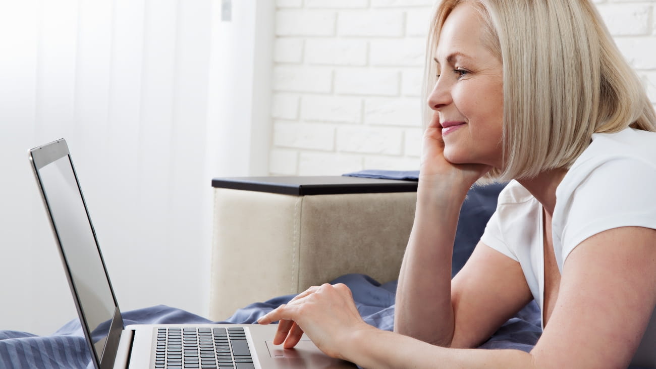 A lady sat in front of a laptop
