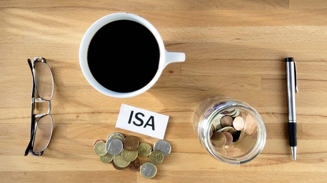 ISA words on desk with coins and pen