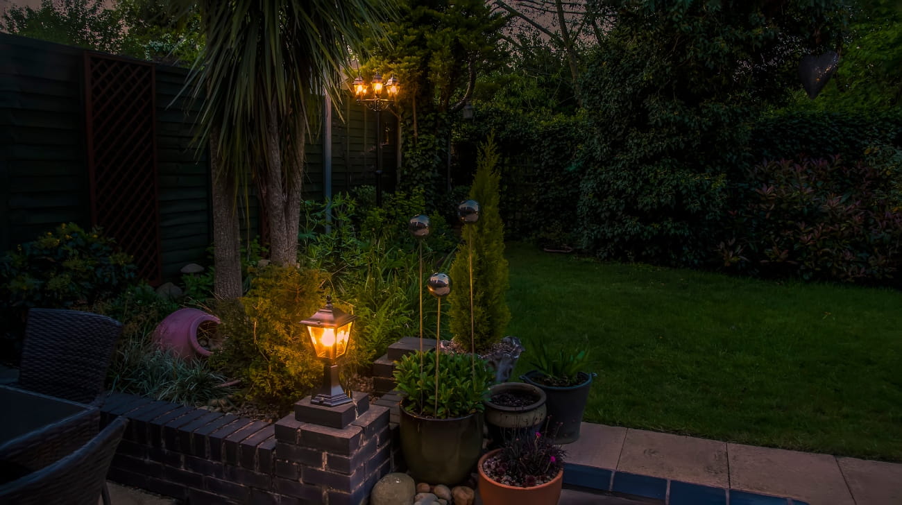 A view of a garden lights and decorations in Market Harborough, UK at night