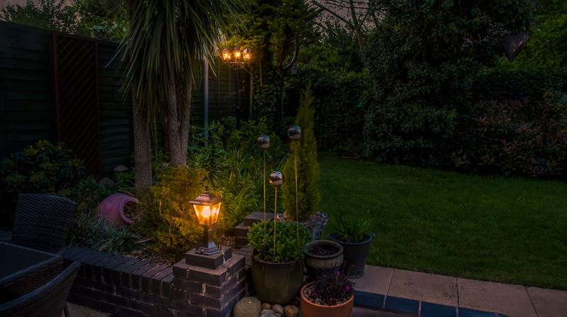 A view of a garden lights and decorations in Market Harborough, UK at night