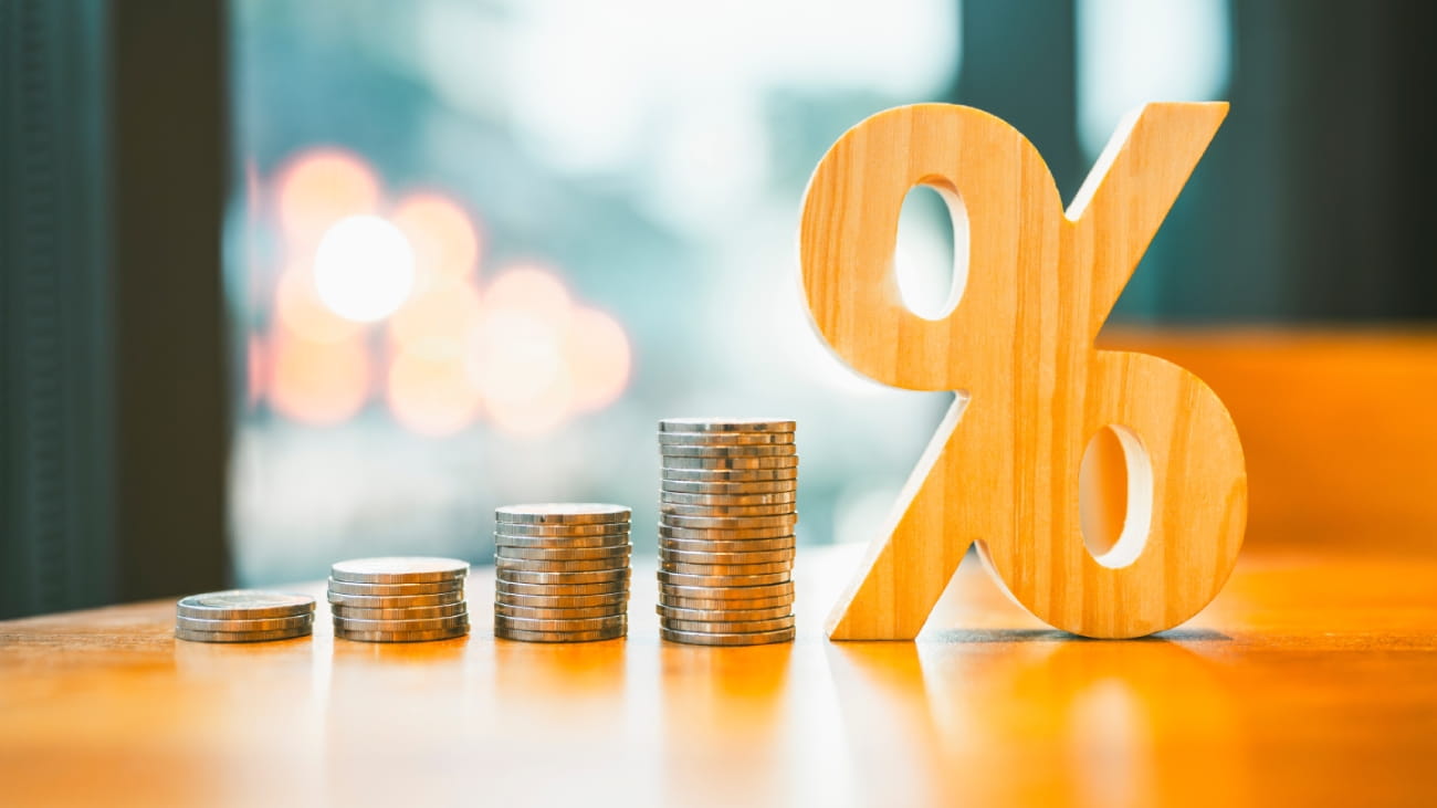 Percentage model with coins stack. Concepts of the banking system, rising interest rates, inflation, deflation, and savings.