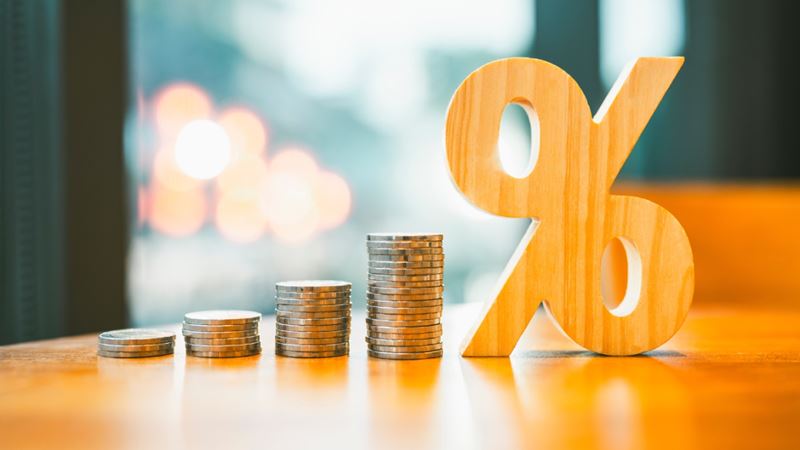 Percentage model with coins stack. Concepts of the banking system, rising interest rates, inflation, deflation, and savings.