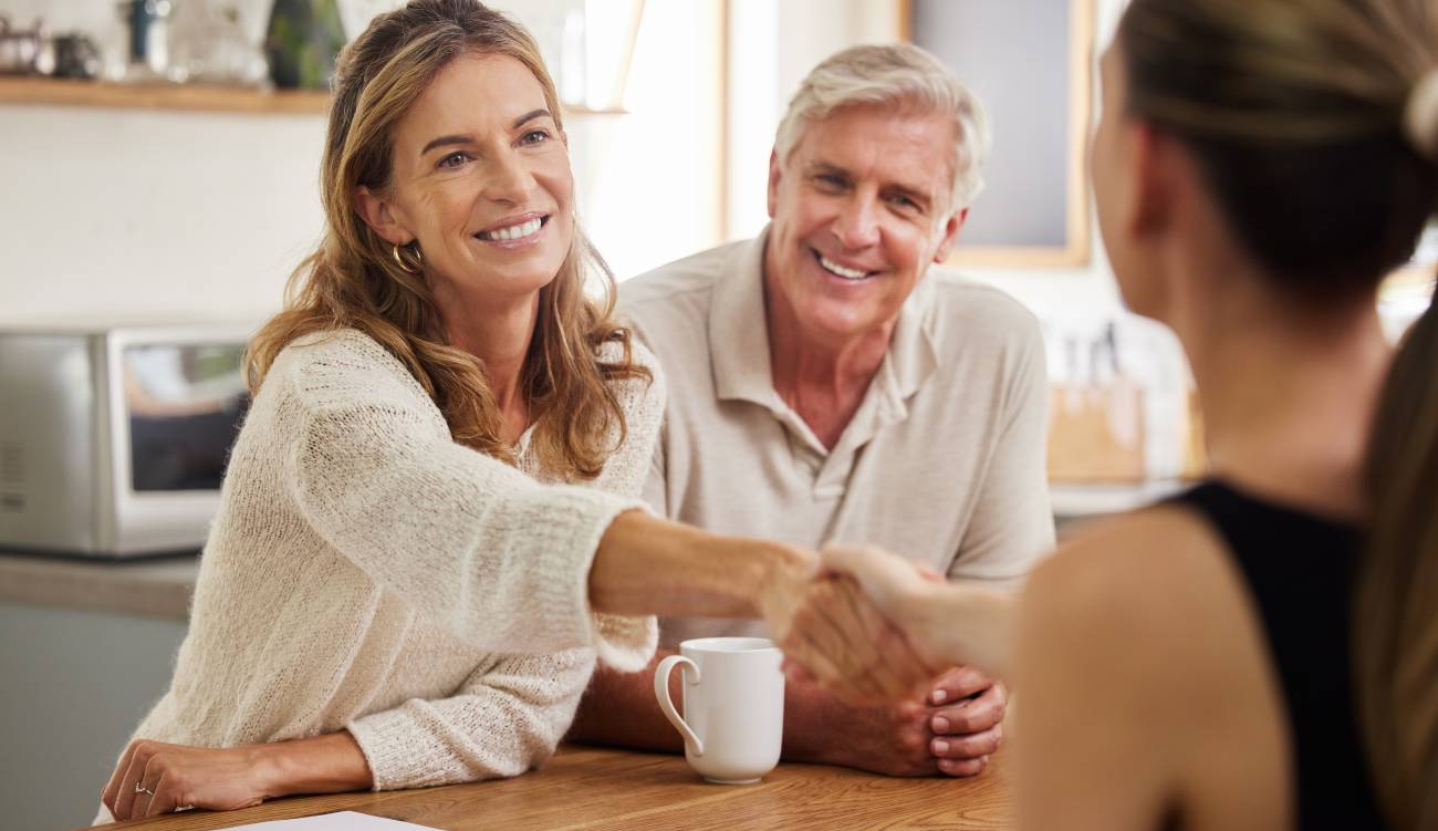 Senior couple sit with lawyer to review tax bills