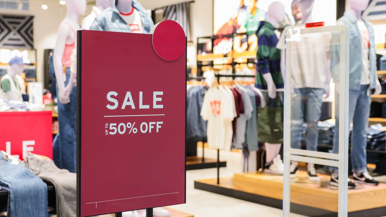 Discount sale label at shop entrance. Sale up to 50 percent, Concept of shopping during discounts on mid year sale.