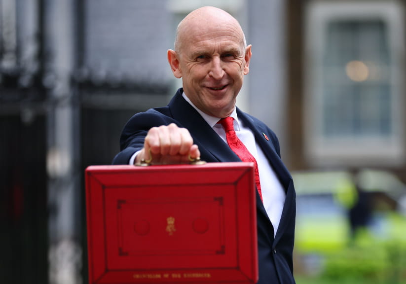 John Healey holding the red budget box