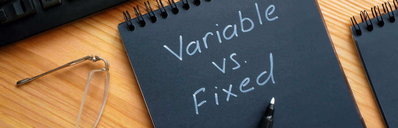 A notepad with variable vs fixed on the cover