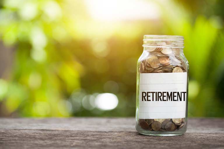 A jar full of coins with a label that reads 'retirement'