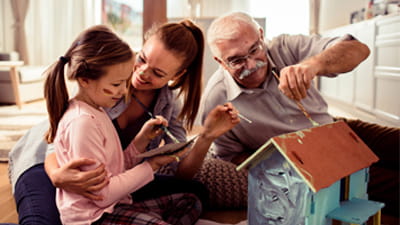 Grand parents with their grandchildren on a sofa at home