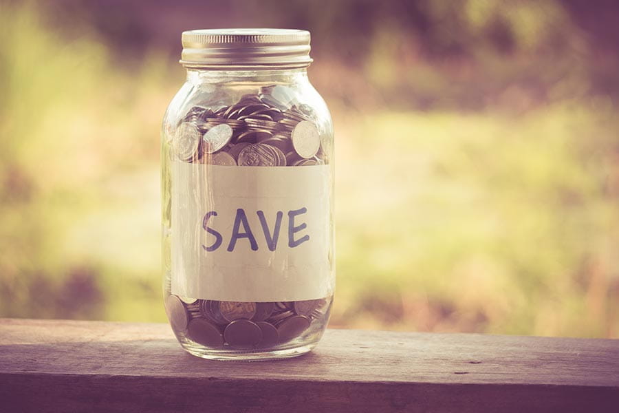 A jar of coins with a label that says save