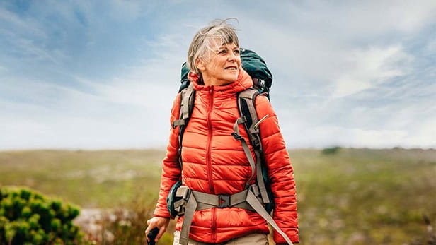 A female hiker out walking across the moors on a bright blue sky day