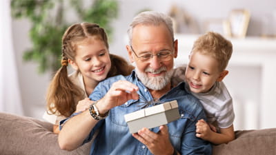 A grandfather with his grandchildren at home