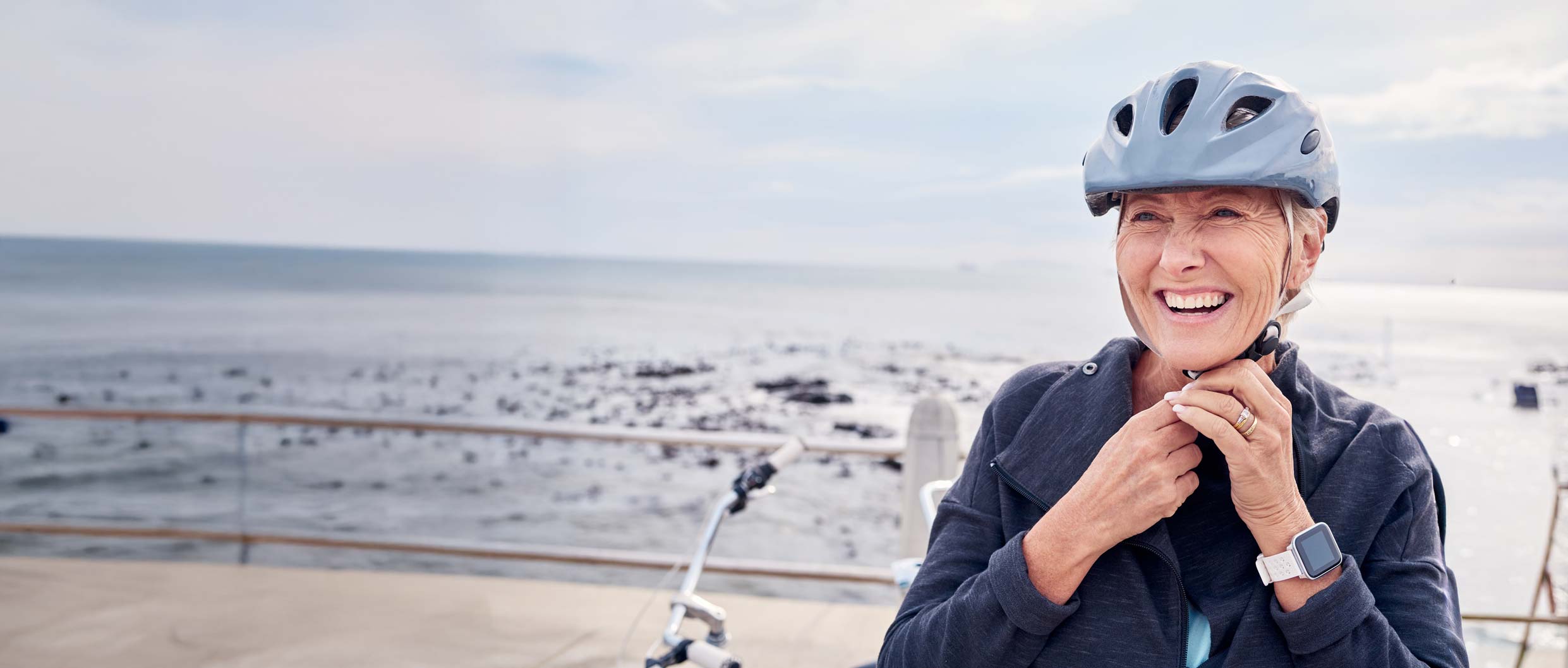 A female cyclist on the promenade by the beach