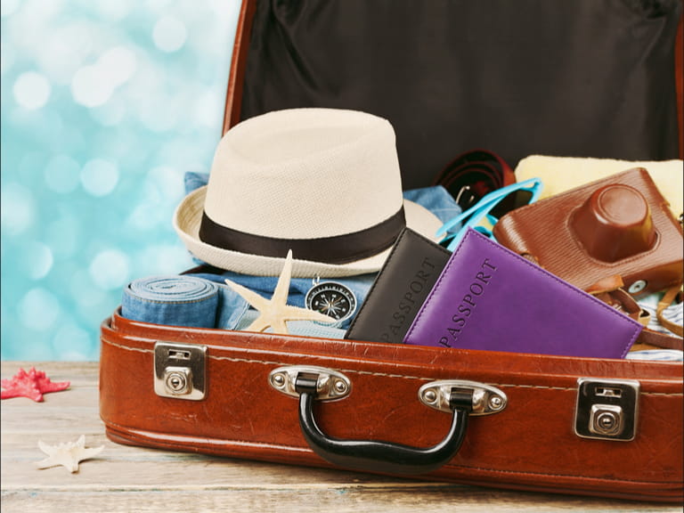 Suitcase with items to pack for a touring holiday