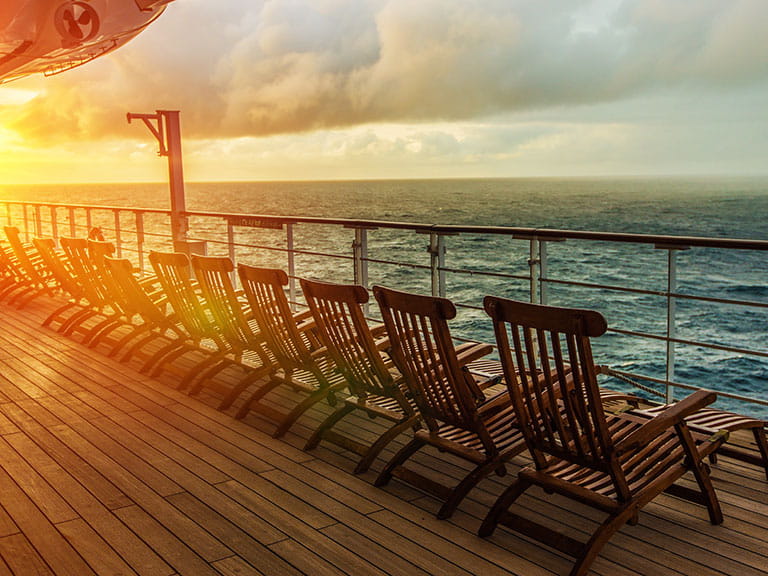 The sun sets over the deck chairs