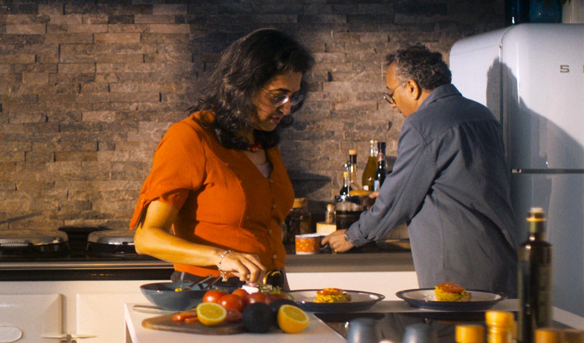 A couple cooking together in a kitchen